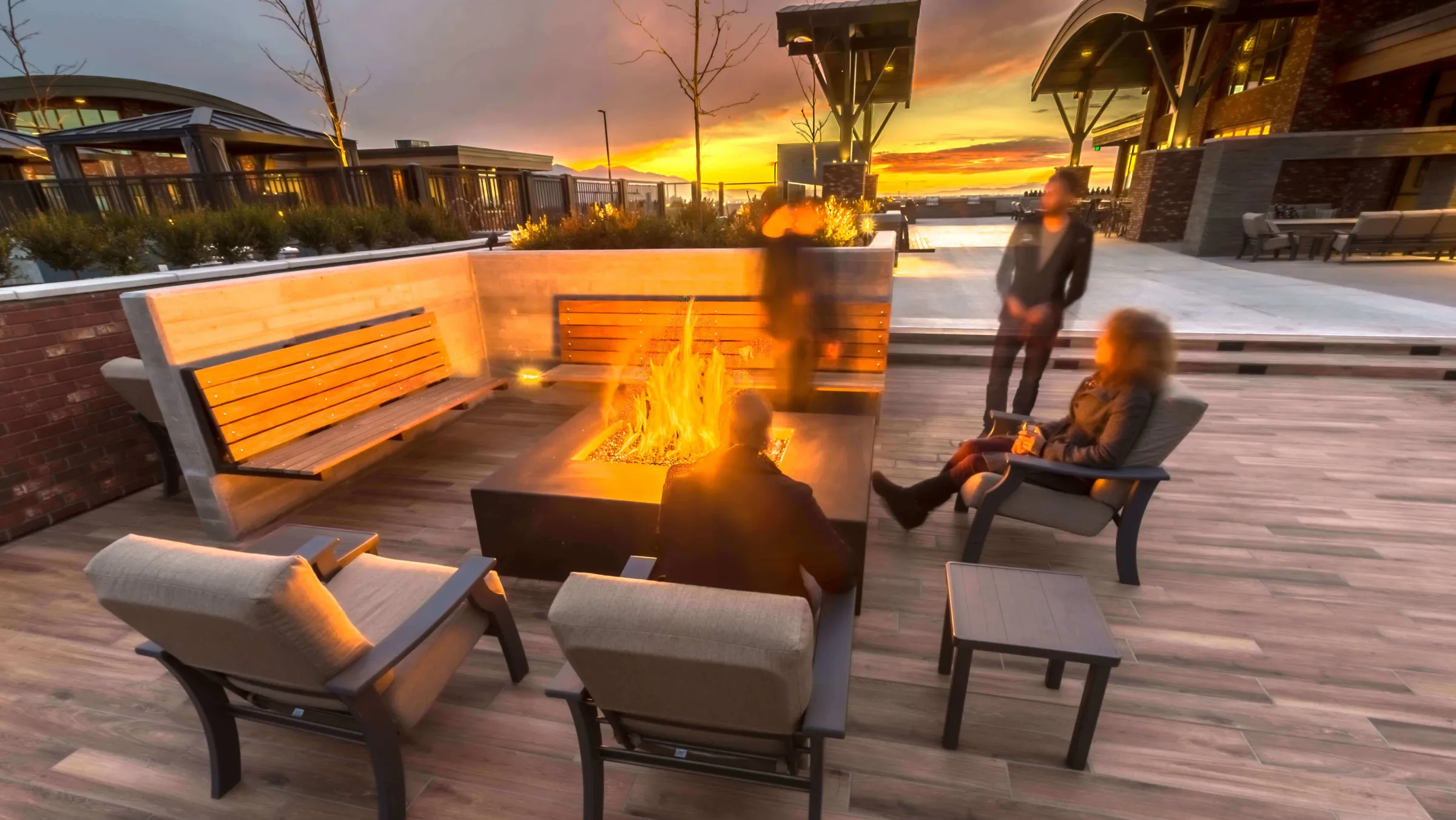 STAND-IN BRANDON TO VET — fire pit at night with deck illuminated and mountain backdrop