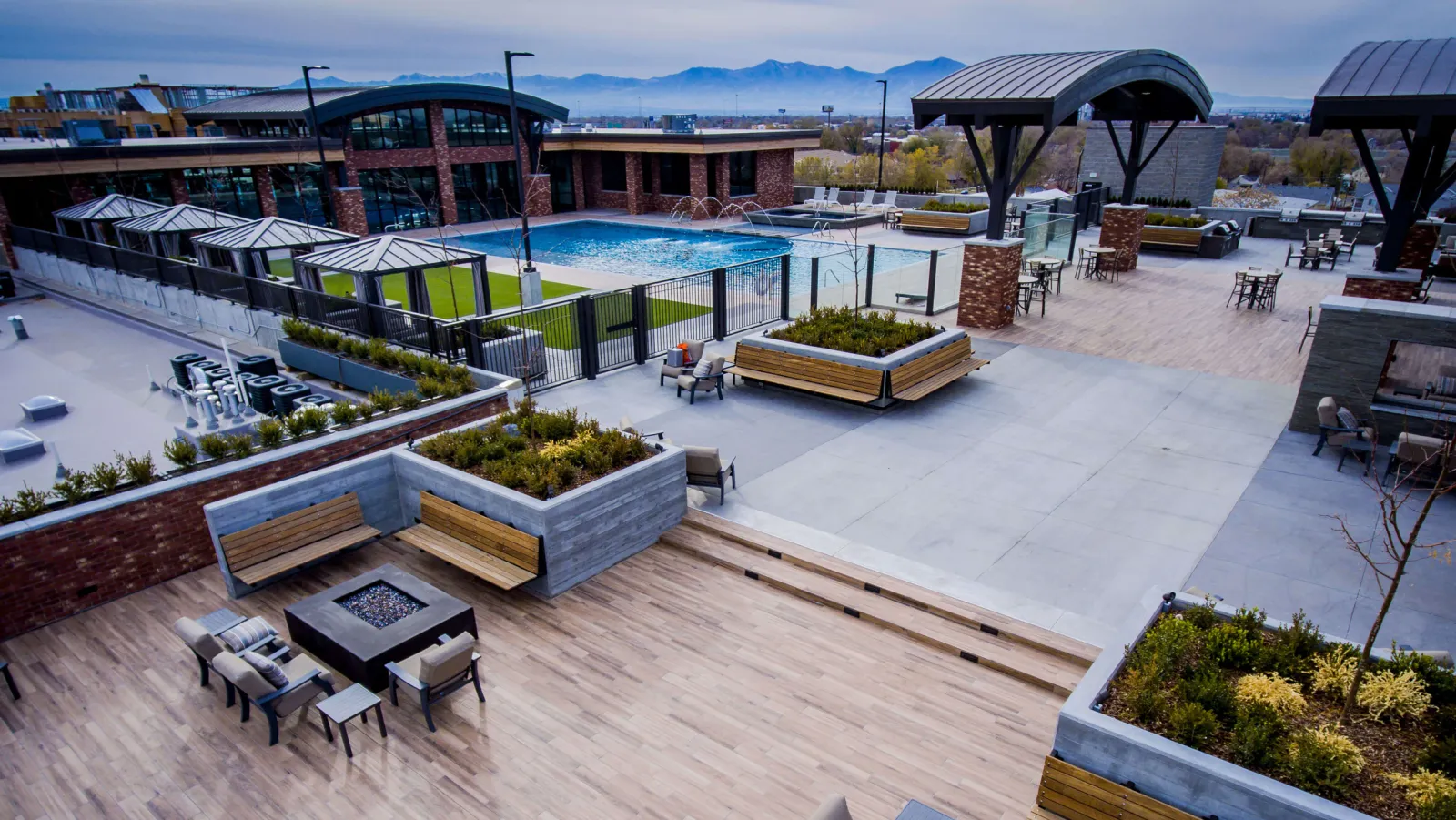 STAND-IN BRANDON TO VET — 4th West rooftop aerial showing the Olympic pool, cabanas, and Salt Lake skyline