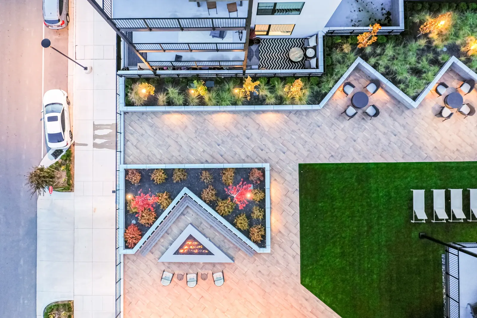 An aerial dusk view of a chevron pavilion and outdoor kitchen, Grandeur