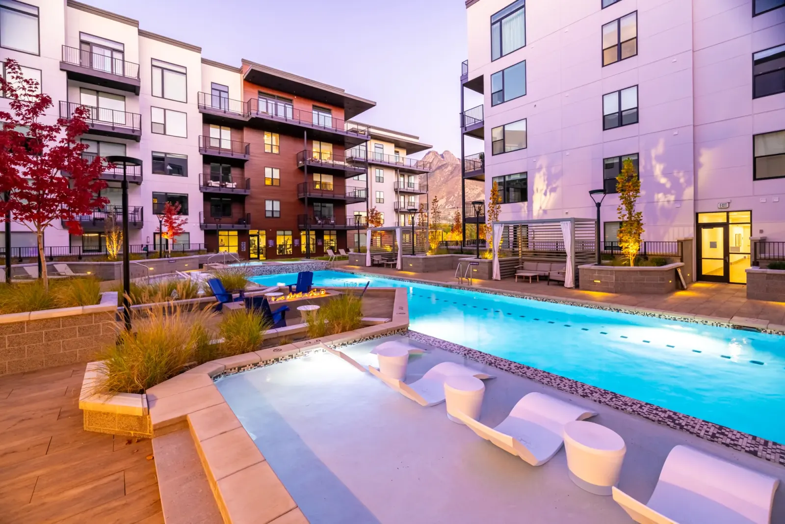 Grandeur pool deck at dusk with in-water loungers