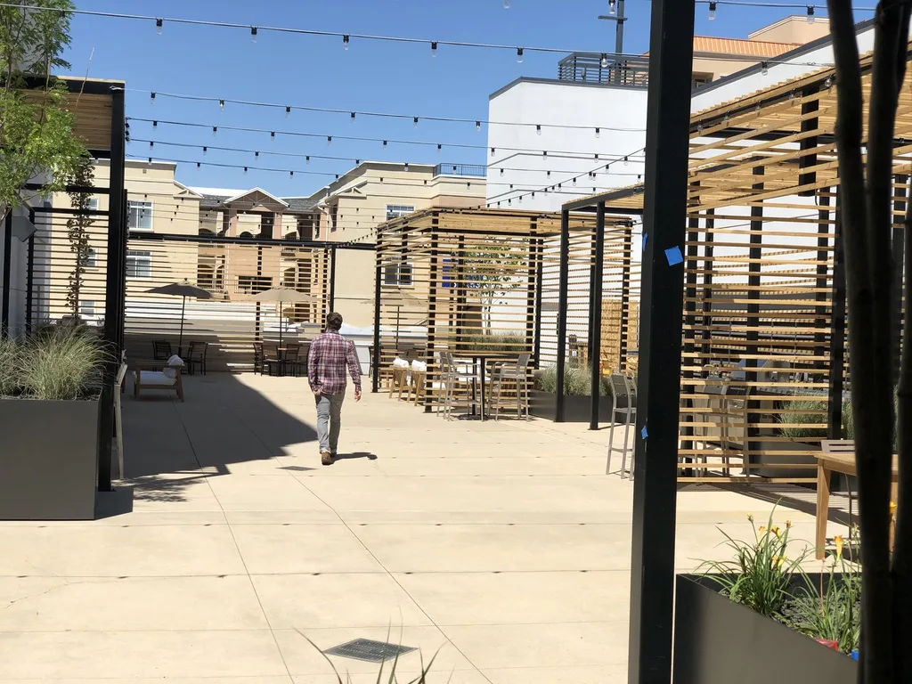 STAND-IN BRANDON TO VET — Hidden Gem AFTER: finished rooftop with planters + lounge