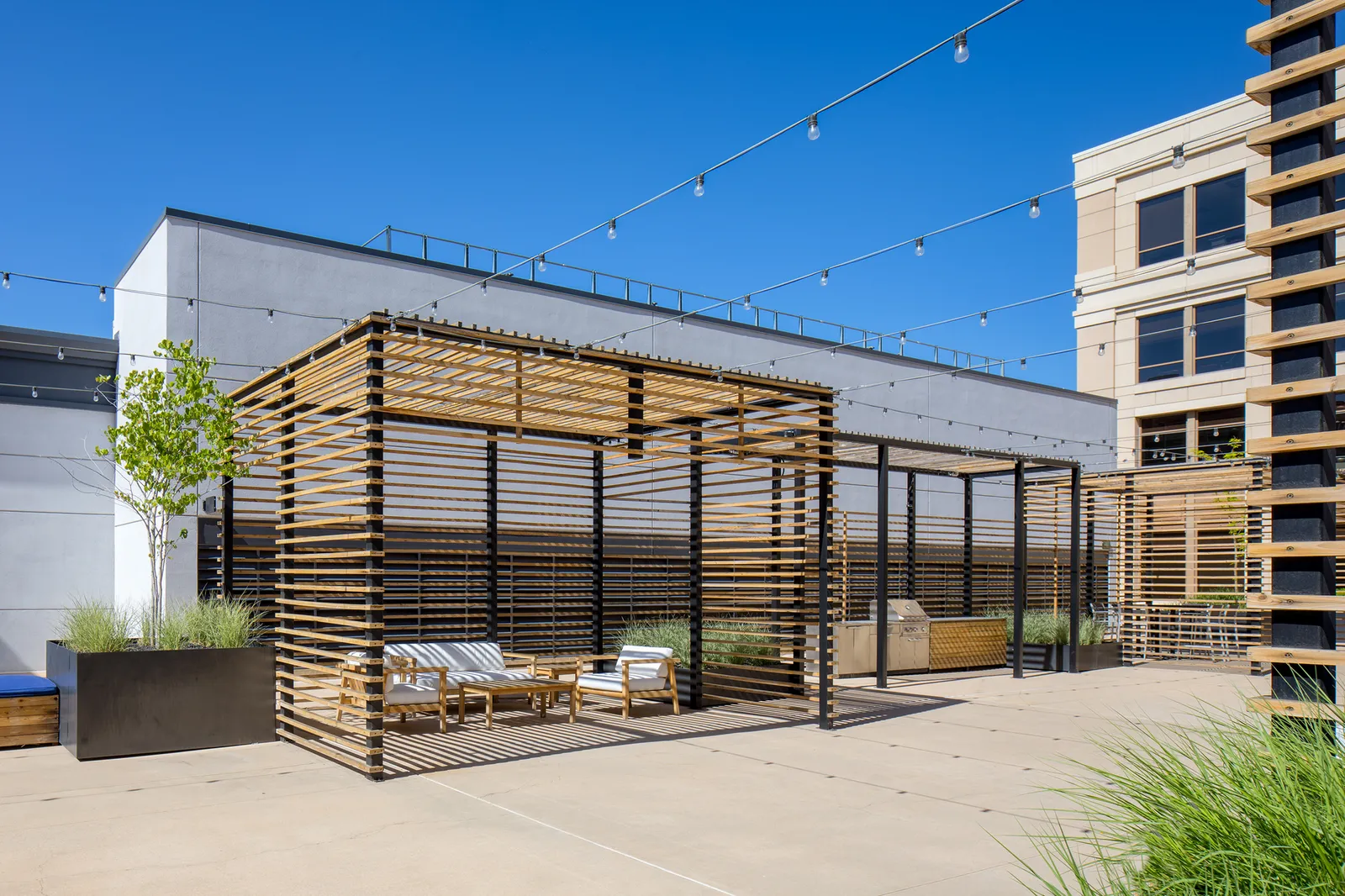 STAND-IN BRANDON TO VET — Hidden Gem rooftop overview showing the L-shape signature feature