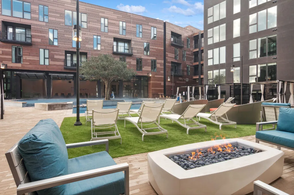 Post House courtyard fire lounge beside the pool, cushions and loungers