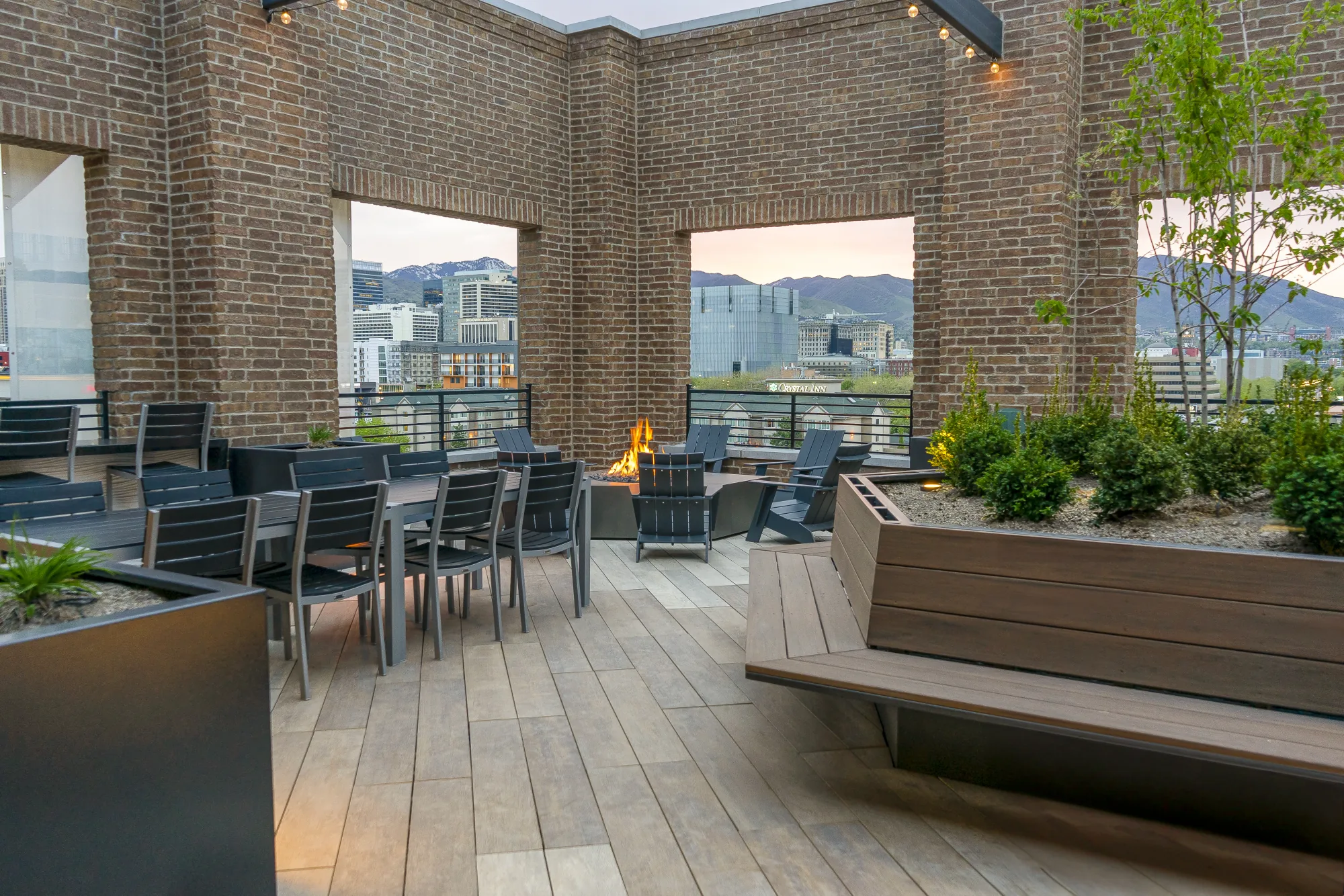 Post House rooftop deck at twilight, firepit lounges over the Salt Lake Valley